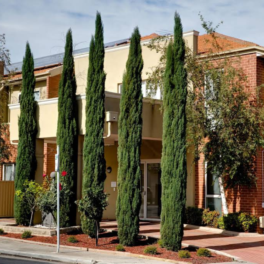 Accessible front entrance of Brunswick aged care facility with wide pathway, level entry, and welcoming landscaping for residents and visitors.