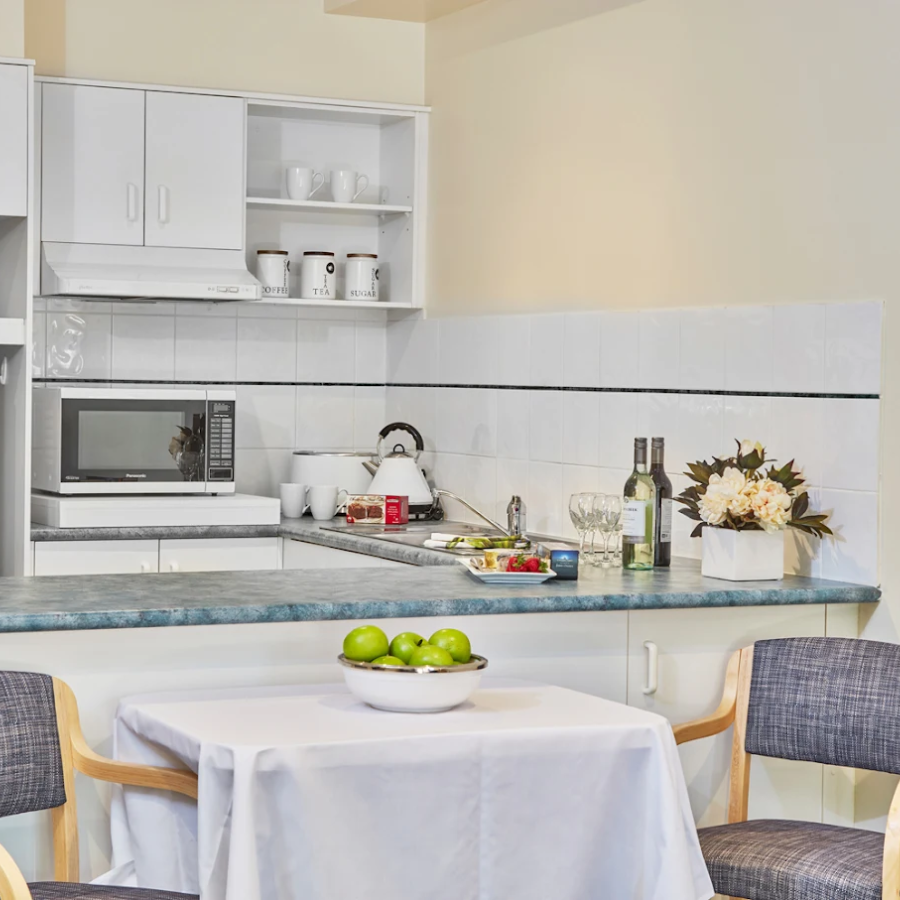 Compact kitchenette and private dining nook supporting independent living within an aged care setting in Highett.