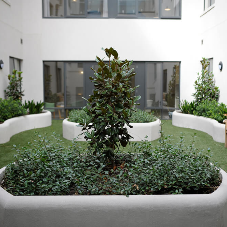Landscaped courtyard with garden beds and seating designed for relaxation at an aged care facility in Beaumaris.
