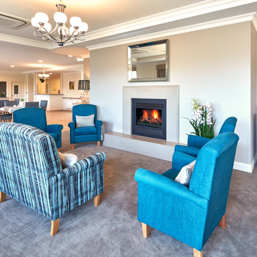 Comfortable lounge space with fireplace at our nursing facility in Heatherton, offering homelike aged care.