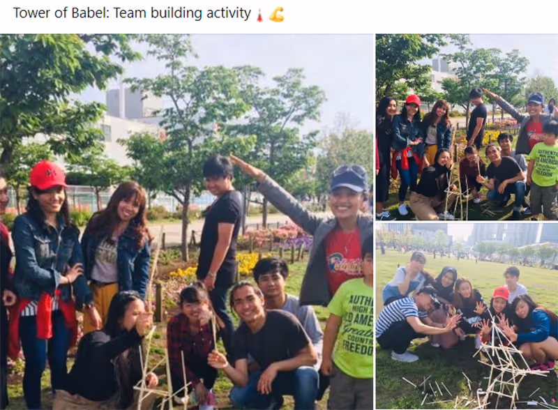 Teams having fun with the tower of babel team building activity