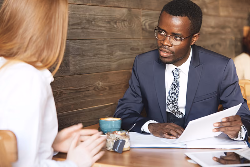 A manager and employee having a discussion about performance KPIs.