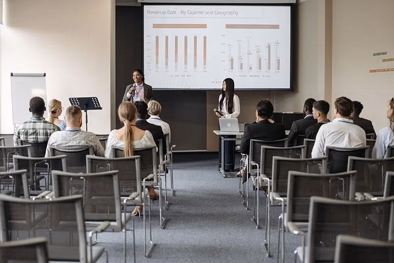 Employees gathered at a presentation where formal recognition is given by a manager