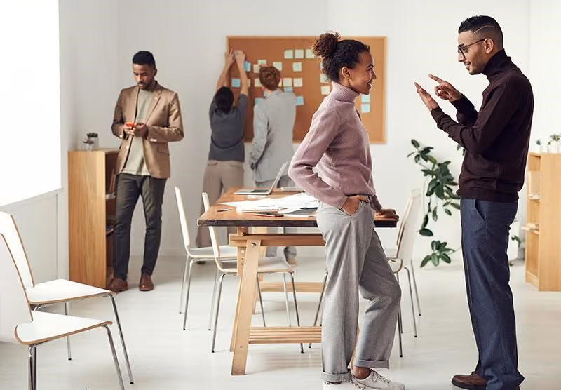 A manager giving informal recognition to an employee after a meeting