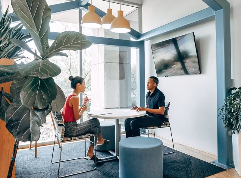 A manager recognizes an employee’s progress during a private meeting.