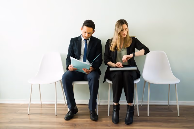 Job candidates waiting outside an interview room.