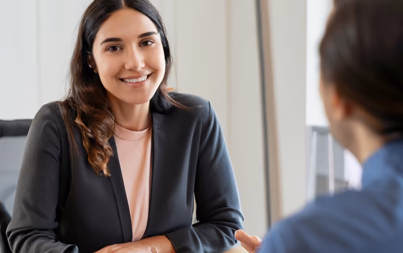 Recruiter displaying attentive body language as an active listening technique.