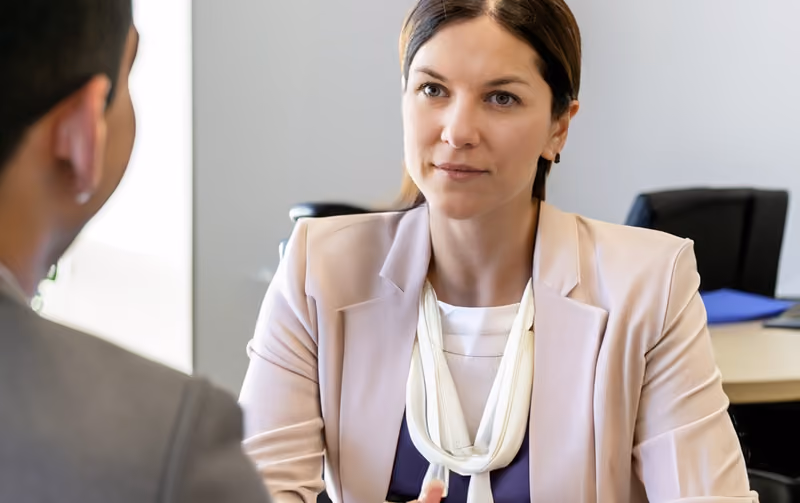 An exiting employee receiving career guidance from an outplacement service provider.