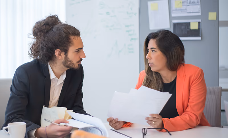 A one-on-one meeting between an HR professional and an employee who is getting laid off.