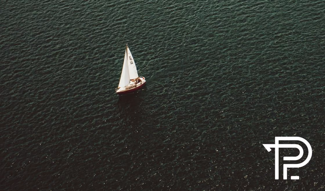 A sailboat on open waters with PiperKey logo.