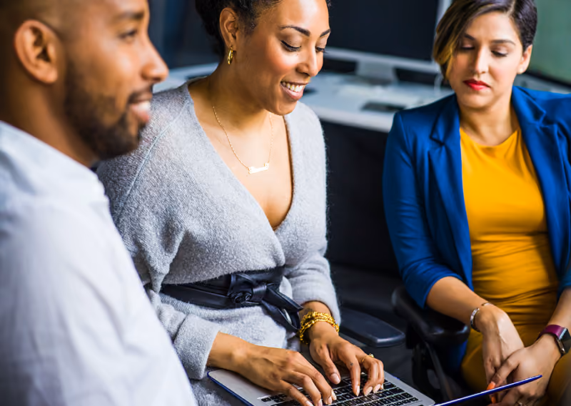 A team of three HR professionals collaborating to write their company’s HR policies.