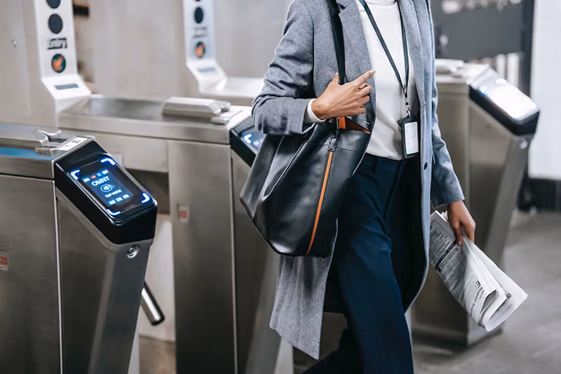 Woman arriving at work and scanning in through lobby security.