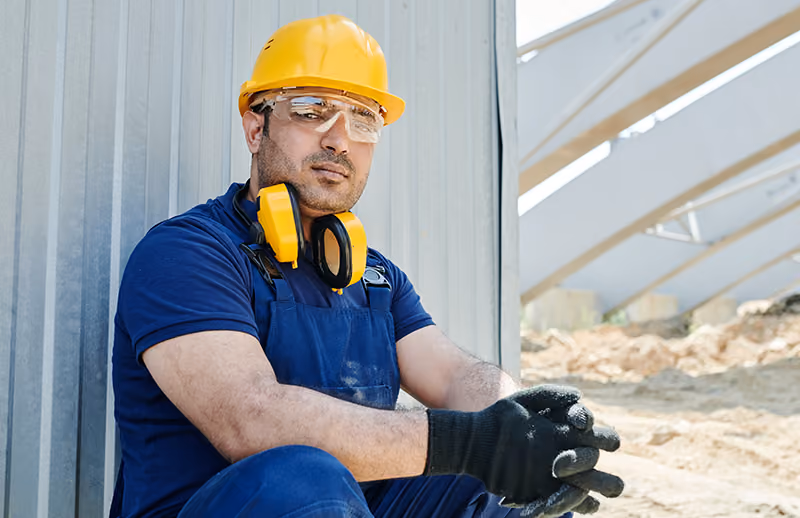 Construction worker wearing PPE in compliance with his employer's safety policy.