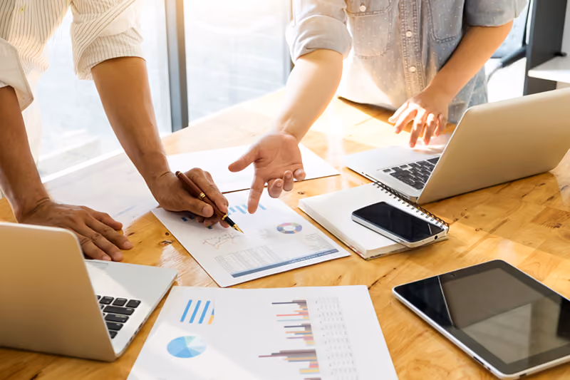 HR professionals making strategic recruitment decisions based on the data from a time and attendance system's reporting