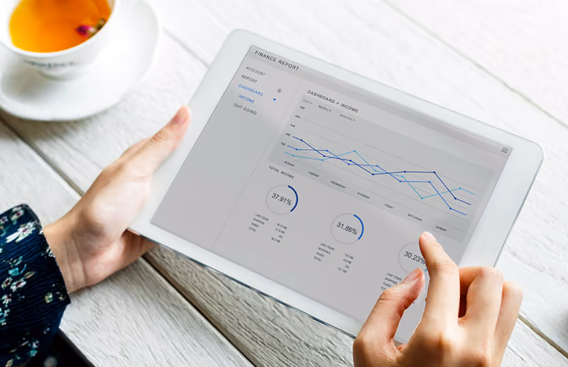 An HR manager uses the reporting features on a company’s time and attendance system to review employee attendance data.