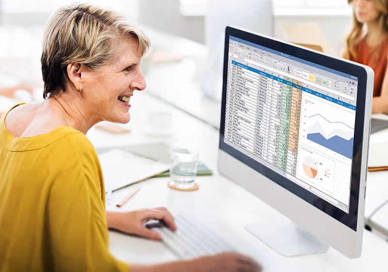 An HR professional using Microsoft Excel to manage employee data.