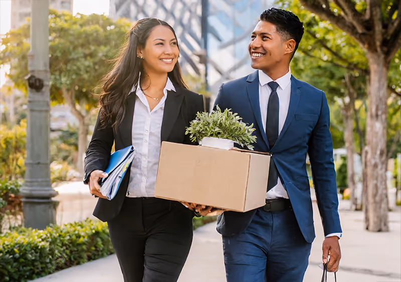 An HR professional wishing an exiting employee well as they leave the office after resigning and completing an exit interview.