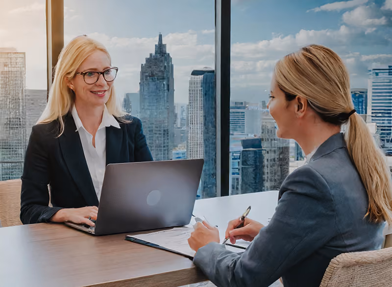 An HR leader mentoring a peopleops professional to develop her written communication skills.