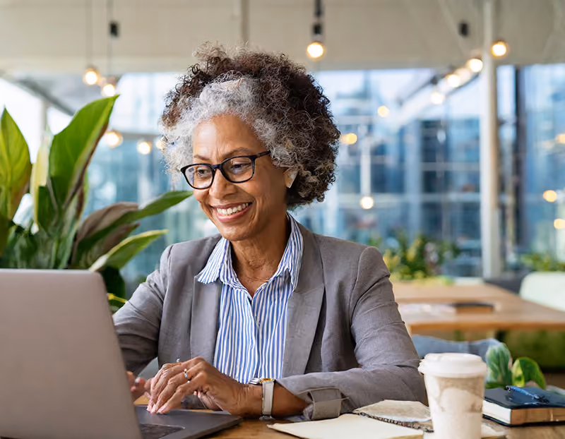 An older professional offering remote mentorship via a video call.