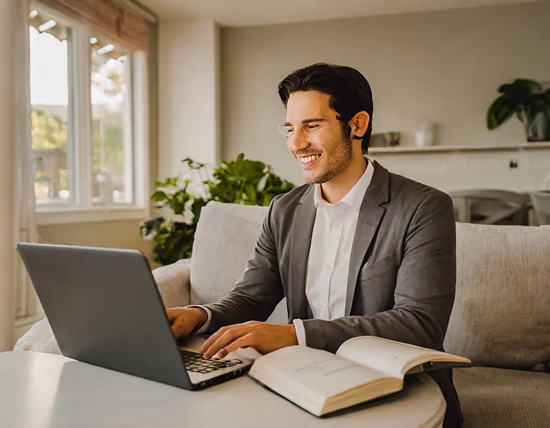 A remote employee at home in a virtual meeting with his mentor.