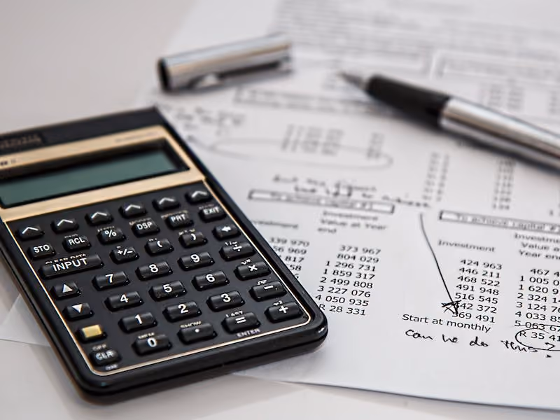 A calculator on top of a spreadsheet showing the numbers of various EOR providers.