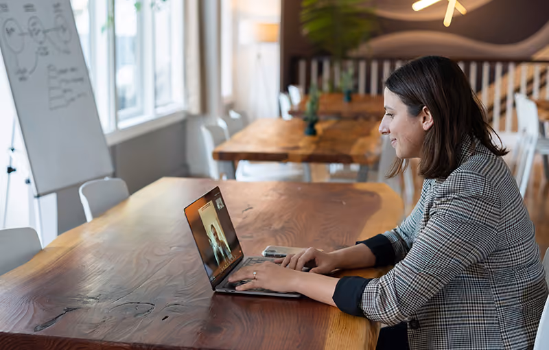 An employee receiving positive feedback in a virtual meeting for beating company sales targets