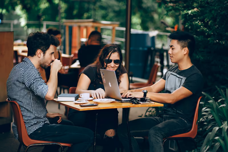 Entrepreneurs doing business at a small cafe.