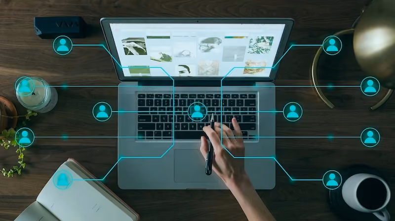 Referral network web hovering over laptop used by woman