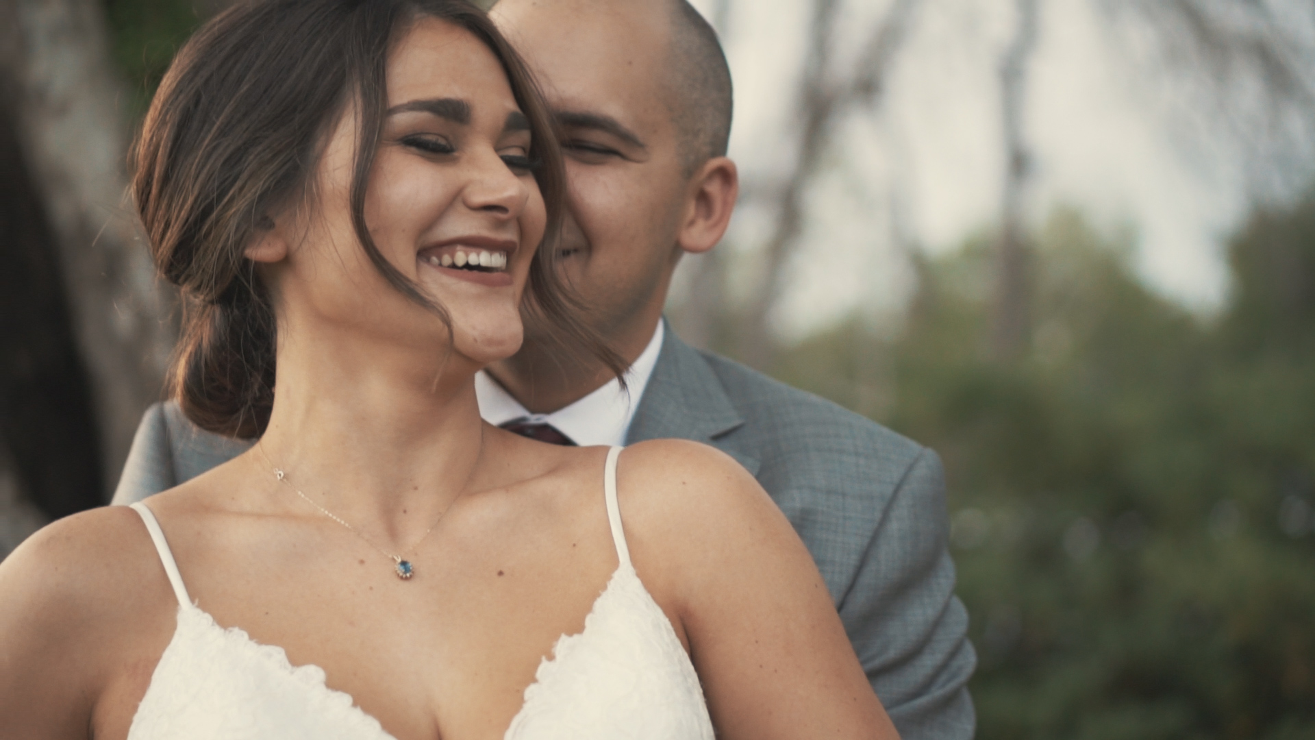 Beautiful bride and groom under umbrella on wedding day - minimalist, artsy shot.