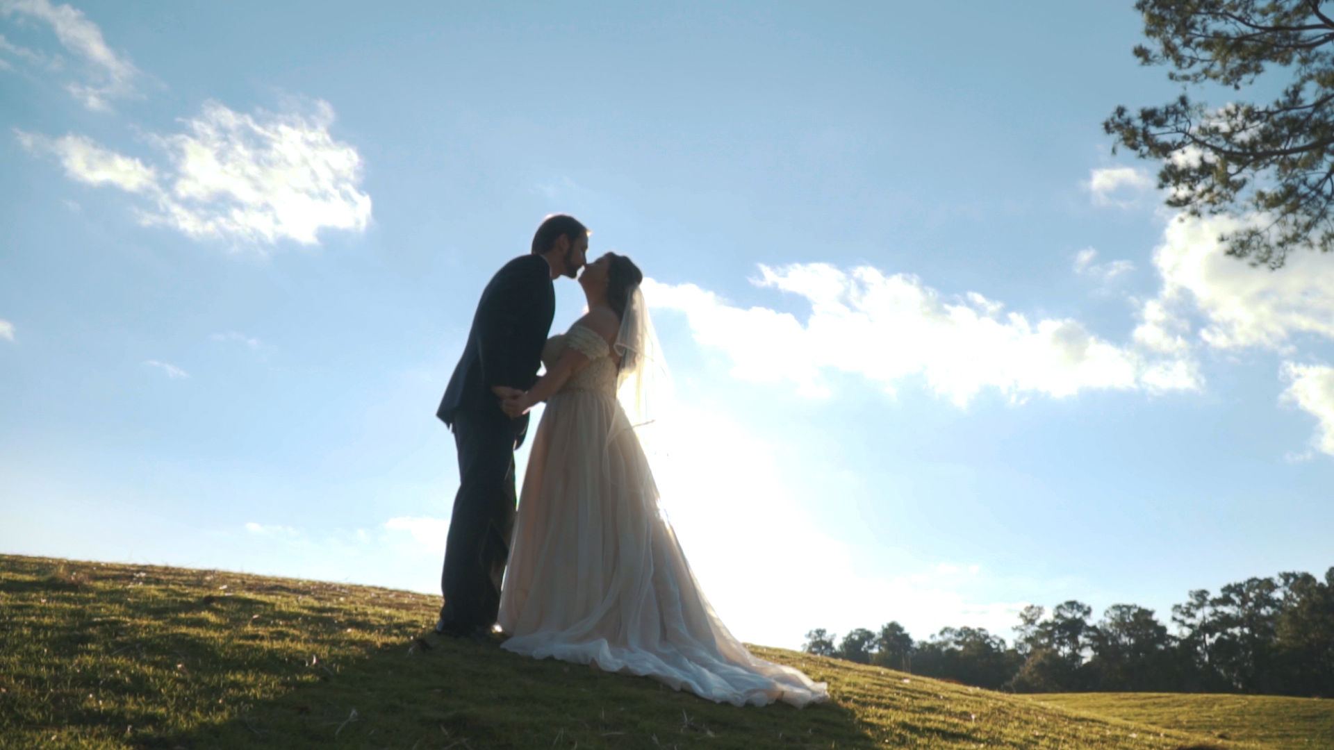 Bride and groom hold hands and read letters to one another during first touch on wedding day.