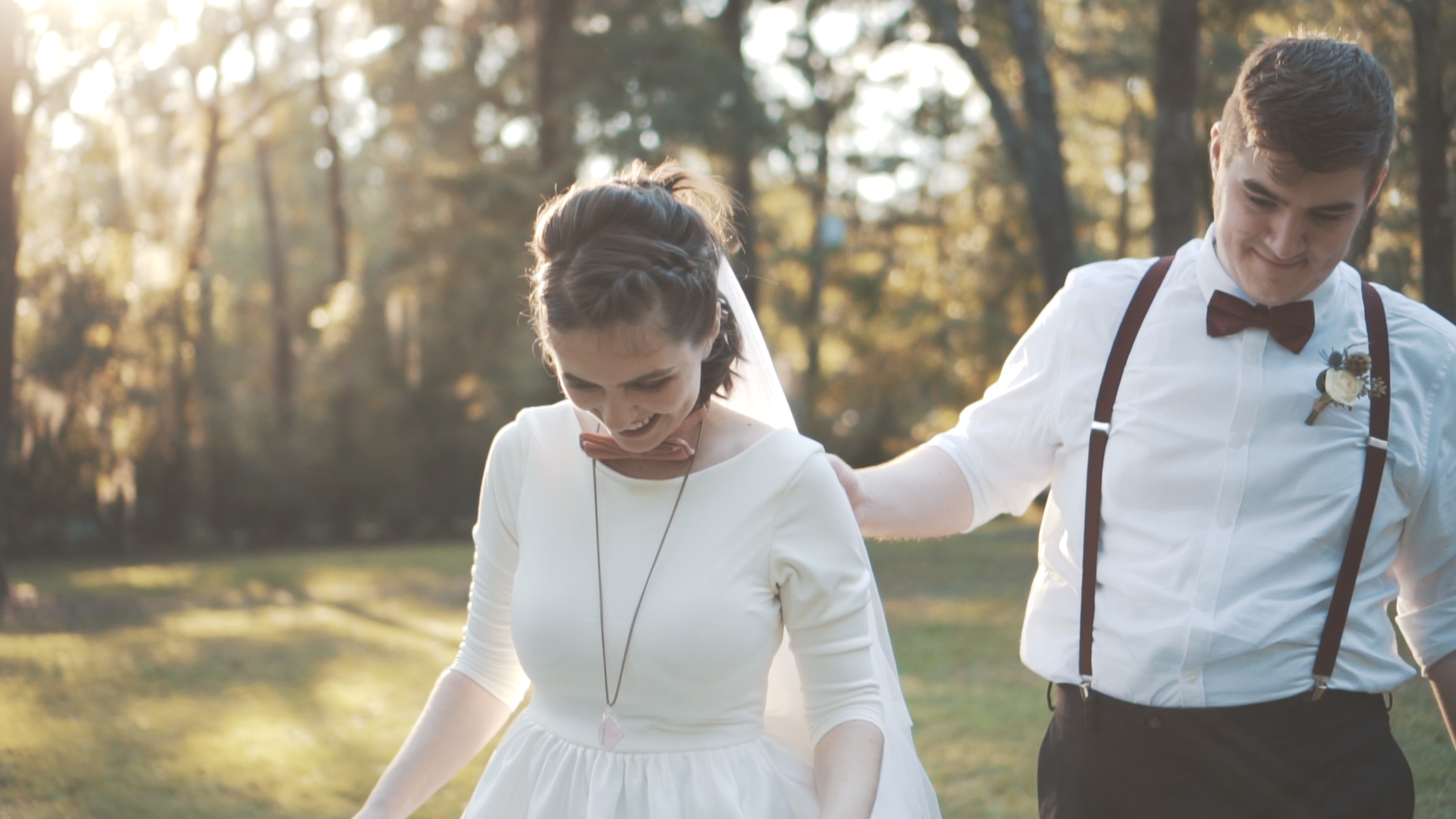 Bride and groom embrace at sunset on the Florida coast.