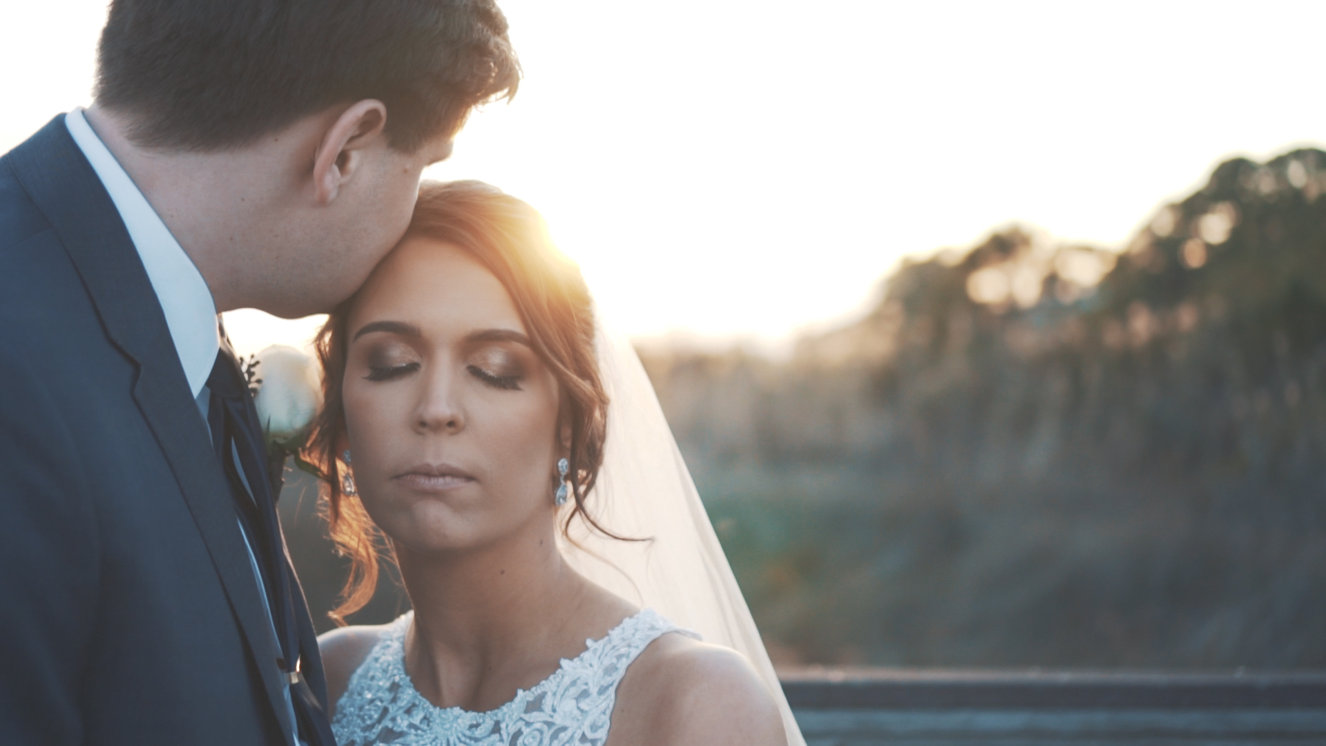 Bride and groom embrace at sunset on the Florida coast.