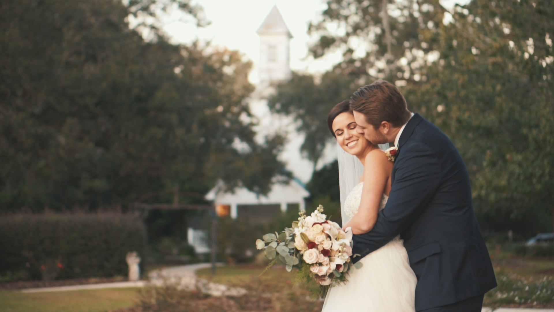 Bride and groom hold hands and read letters to one another during first touch on wedding day.