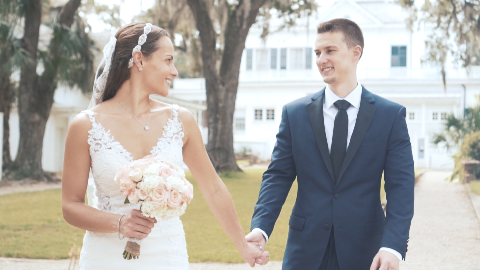 Bride and groom embrace at sunset on the Florida coast.