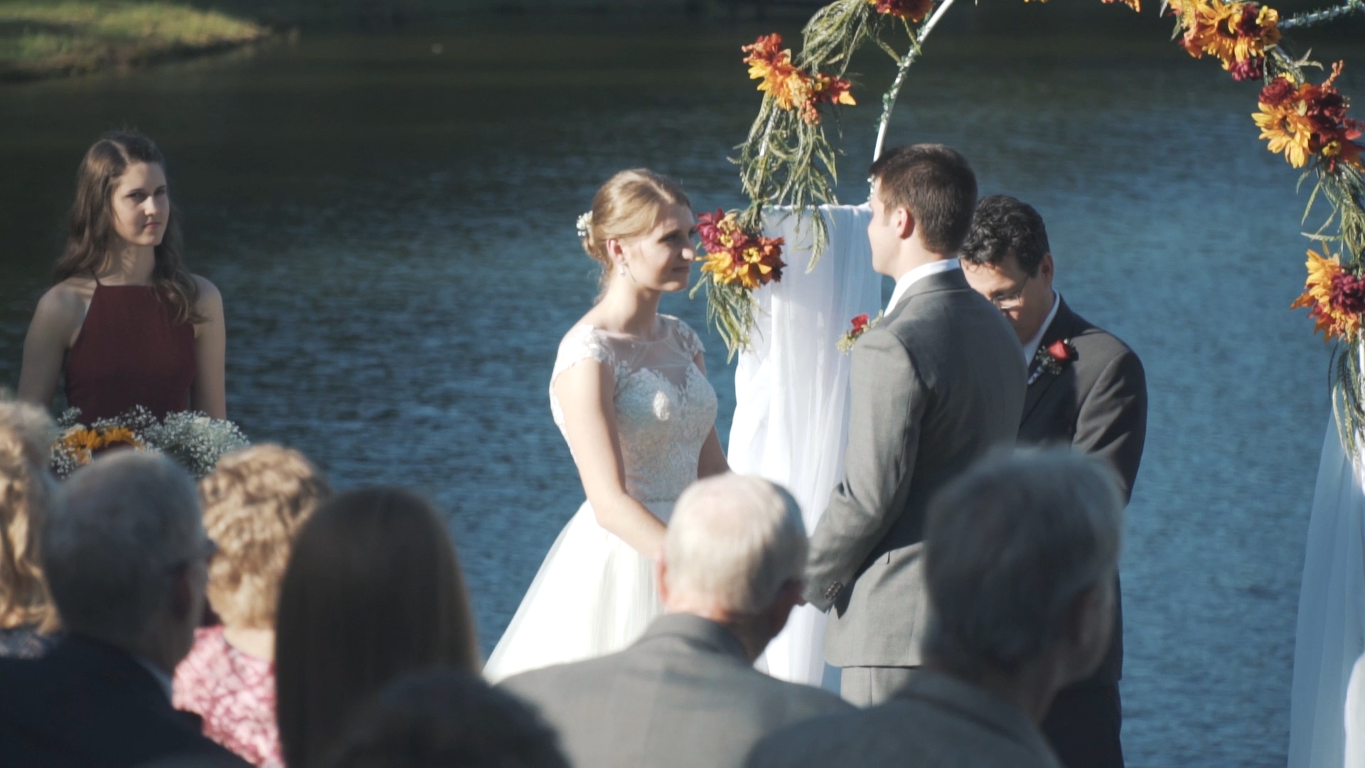 Bride and groom embrace at sunset on the Florida coast.