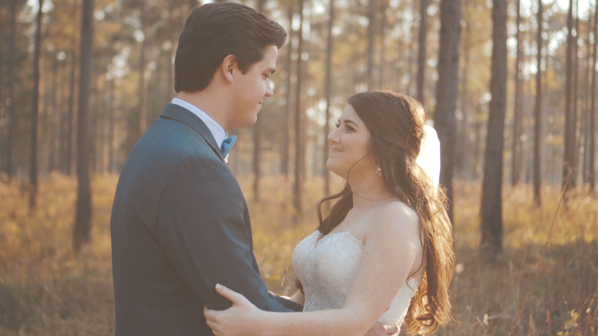 Bride and groom hold hands and read letters to one another during first touch on wedding day.