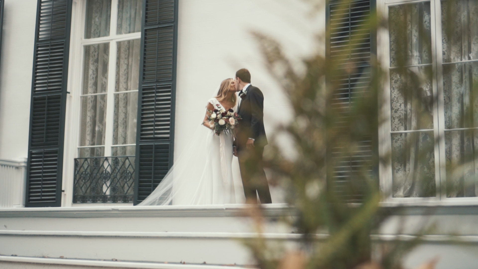 Beautiful bride and groom under umbrella on wedding day - minimalist, artsy shot.