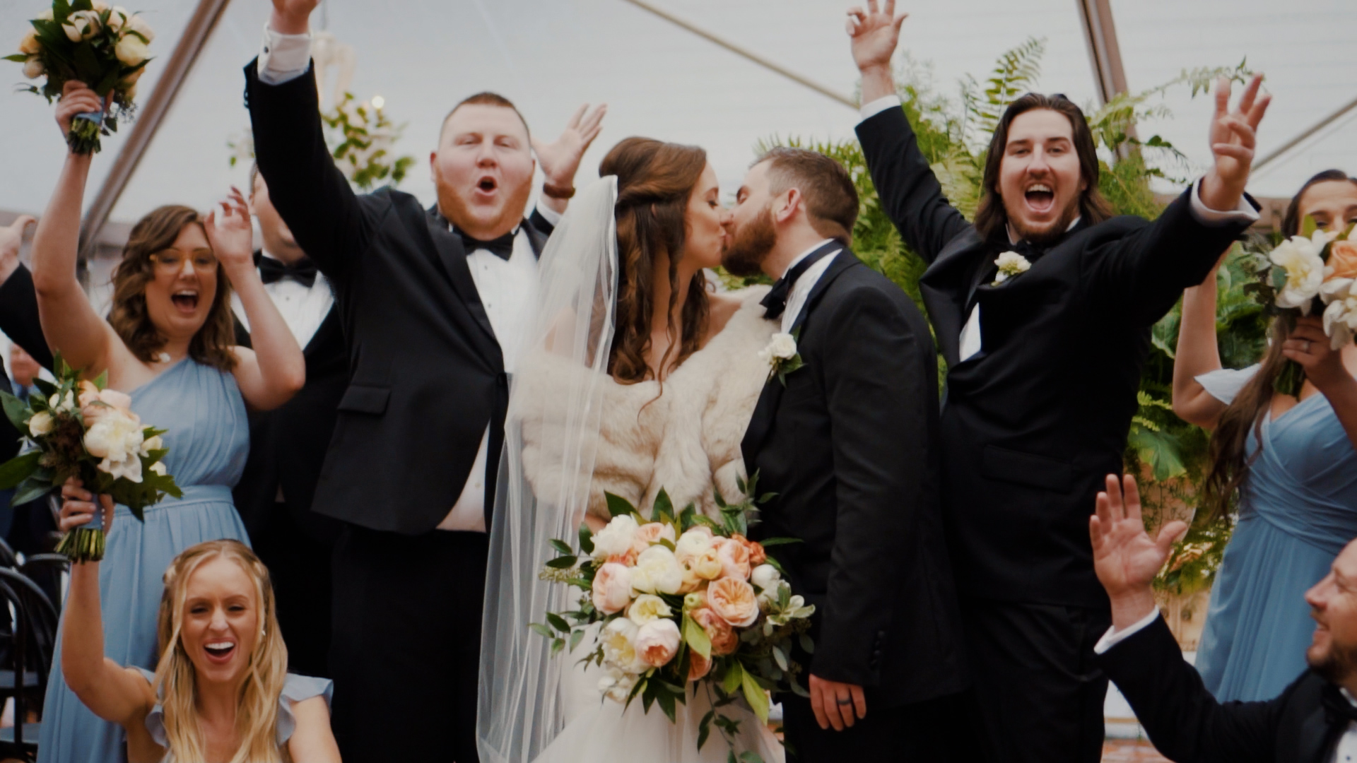 Bride and Groom surrounded by wedding party as they cheer them on!