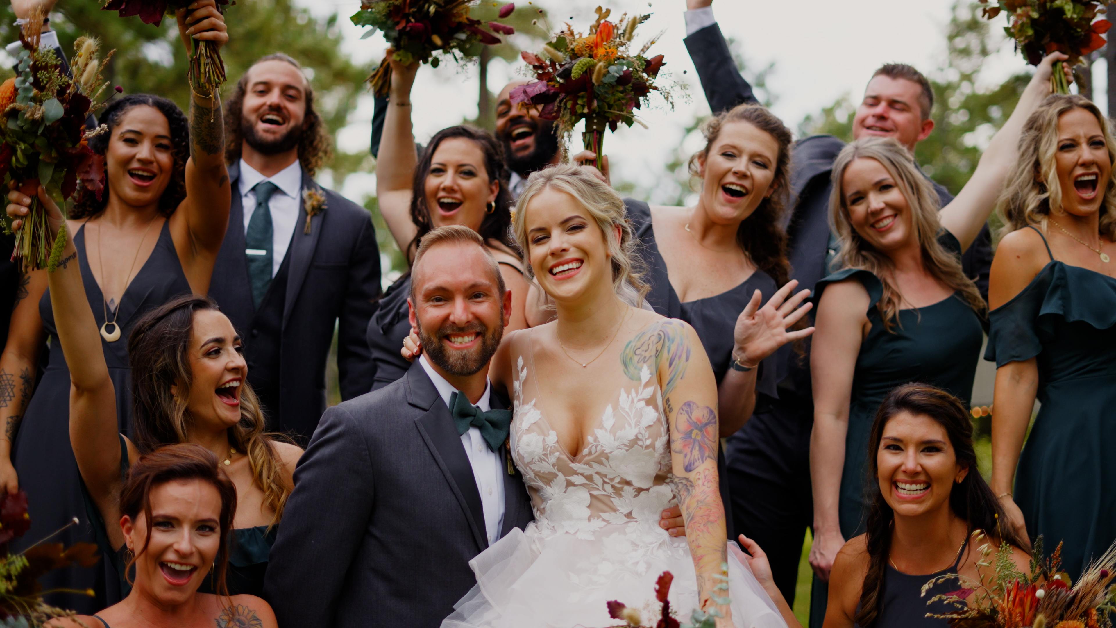 Bride and Groom surrounded by wedding party as they cheer them on!