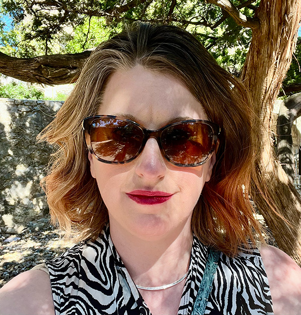 A photo of Shanelle under the shade of a historic live oak in San Antonio