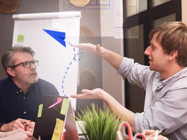Two men discussing Why Zomentum's Proposal Builder Is Better Than Most
