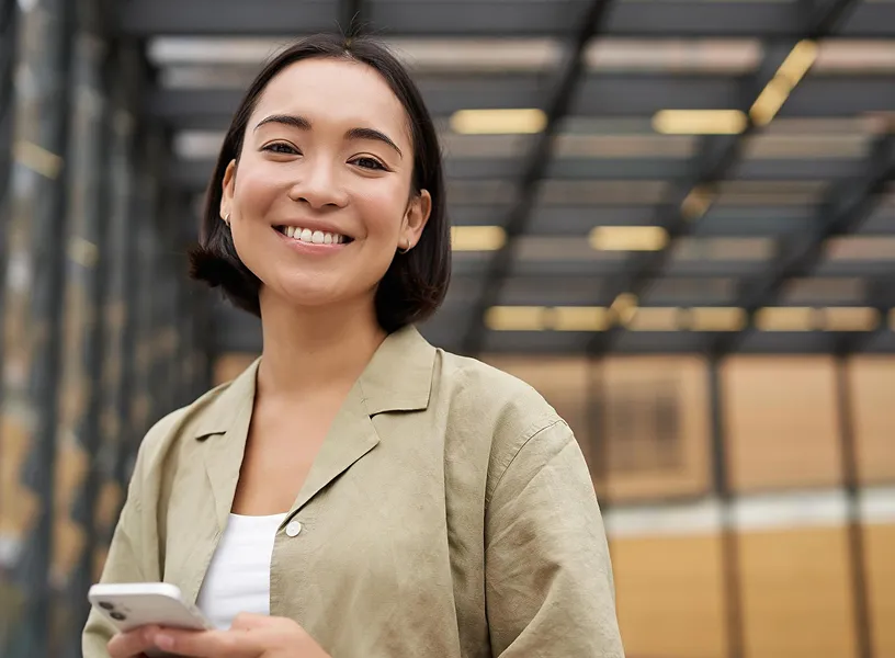 Happy professional using mobile technology, reflecting collaboration and progress at Workpath.