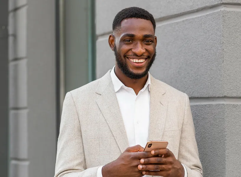 Smiling businessman with smartphone, showcasing agile work culture supported by Workpath.