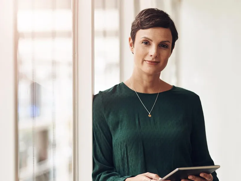 Businesswoman using a tablet, embodying productivity and digital efficiency with Workpath.