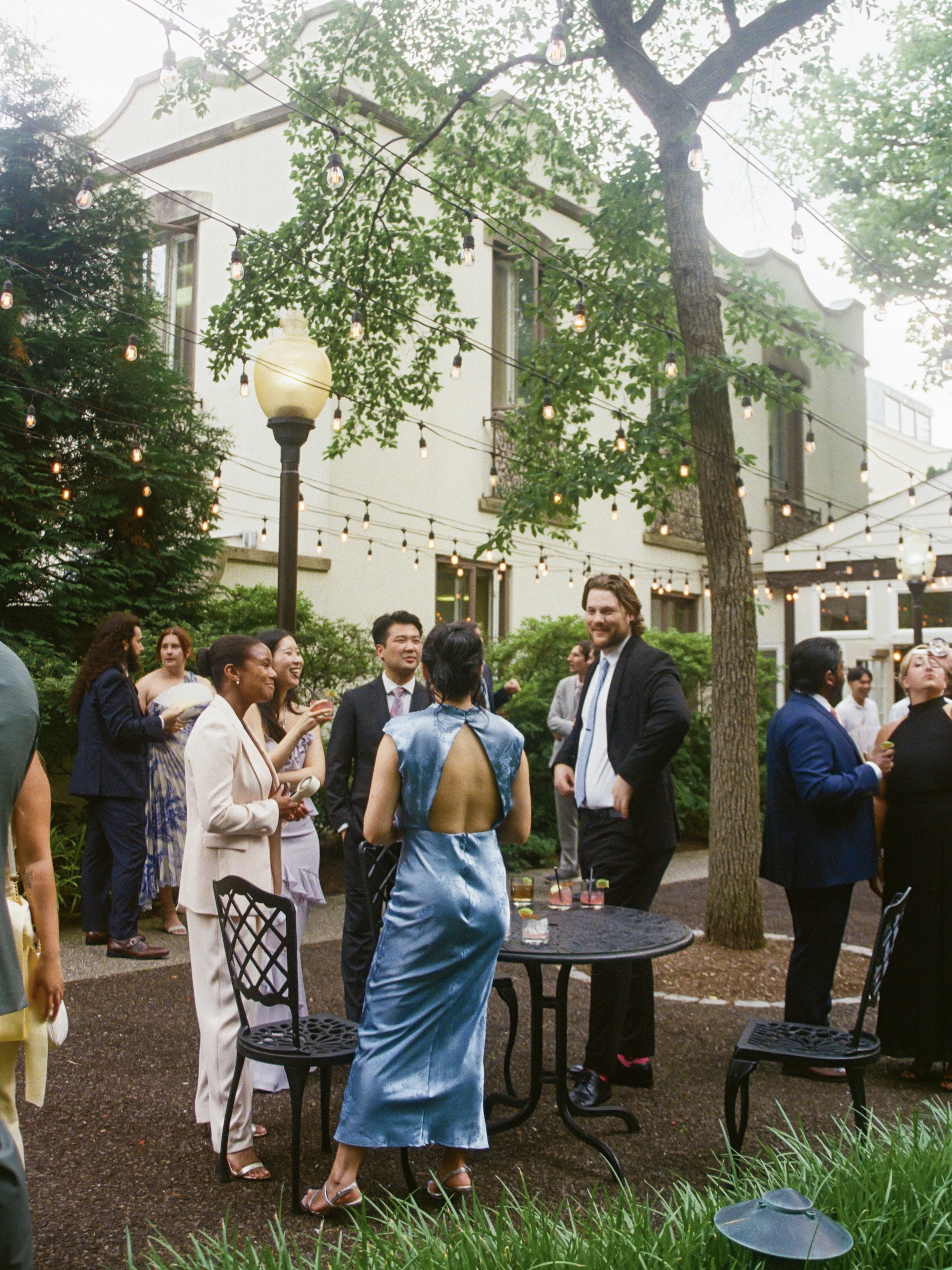 Guests enjoying food and drink during cocktail hour on the patio veranda at Pomme Radnor