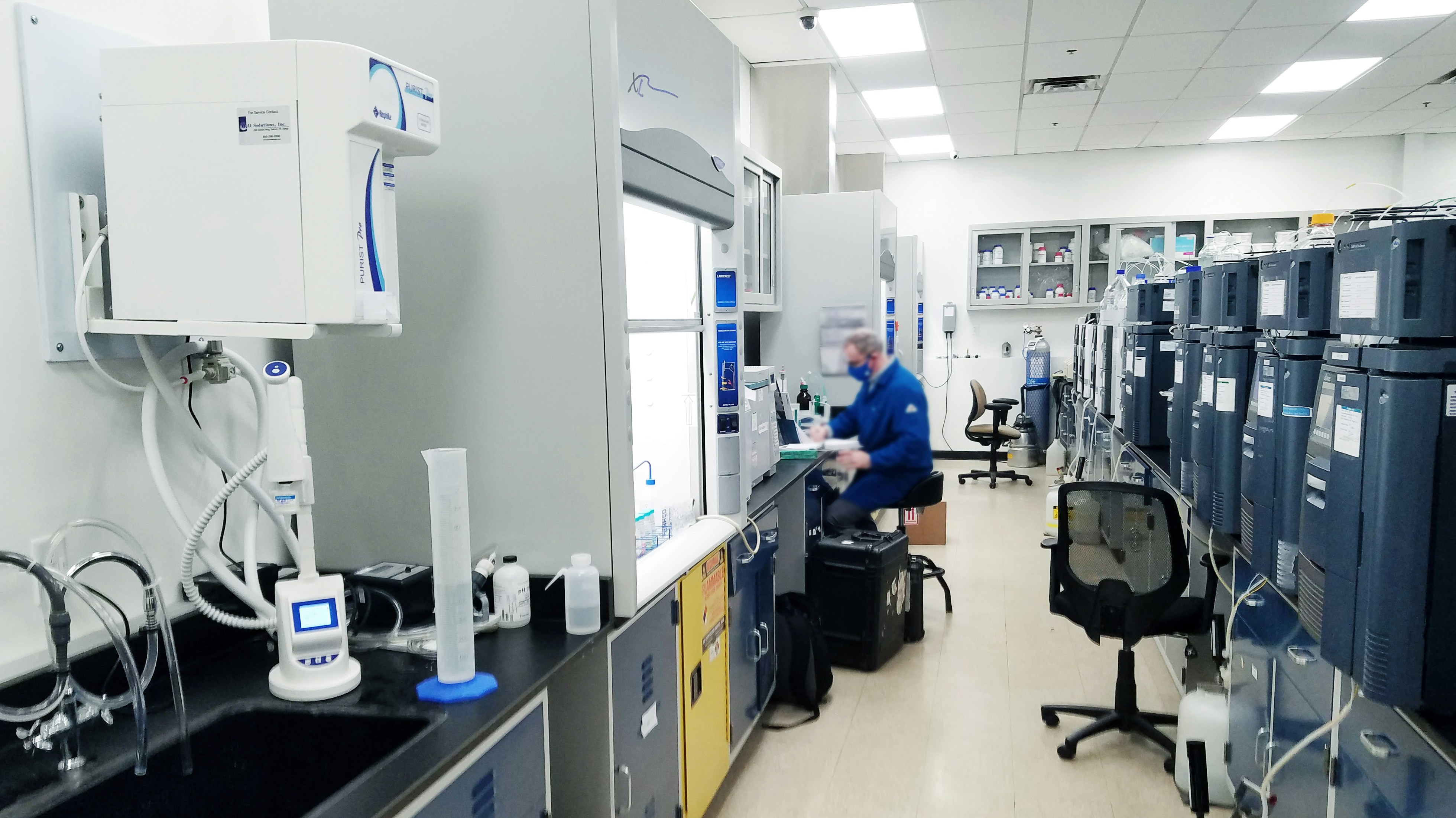 A quality control chemist testing a specialty chemical sample in a laboratory