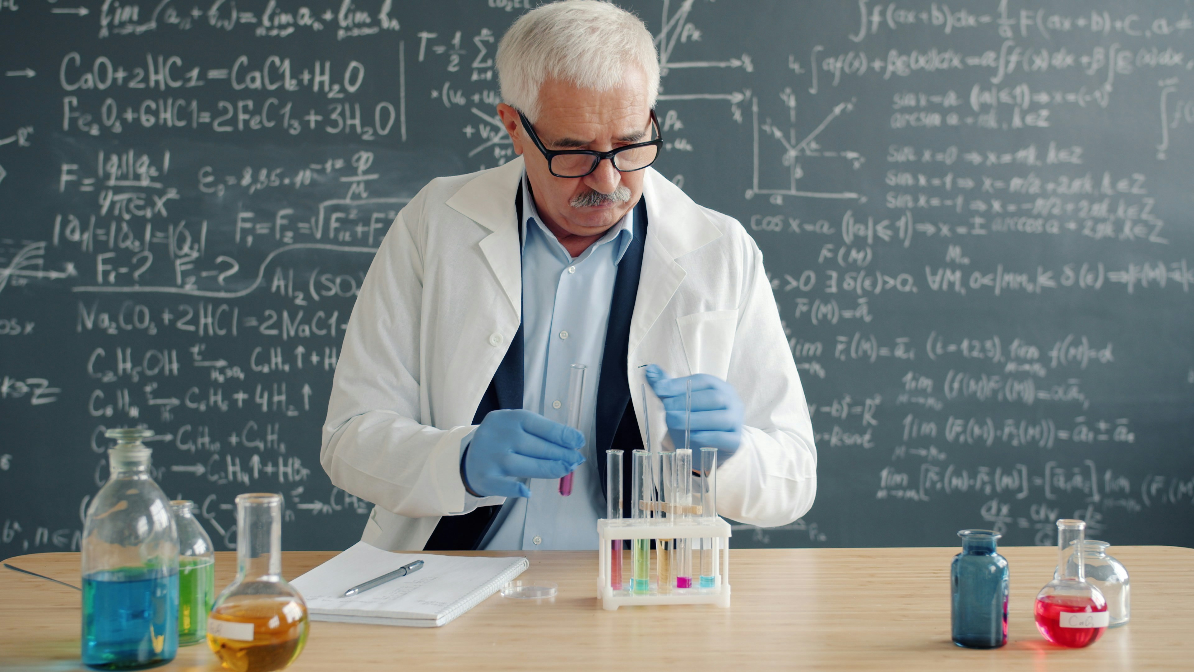A chemist reviewing formulation and raw-material data in a connected R&D platform.