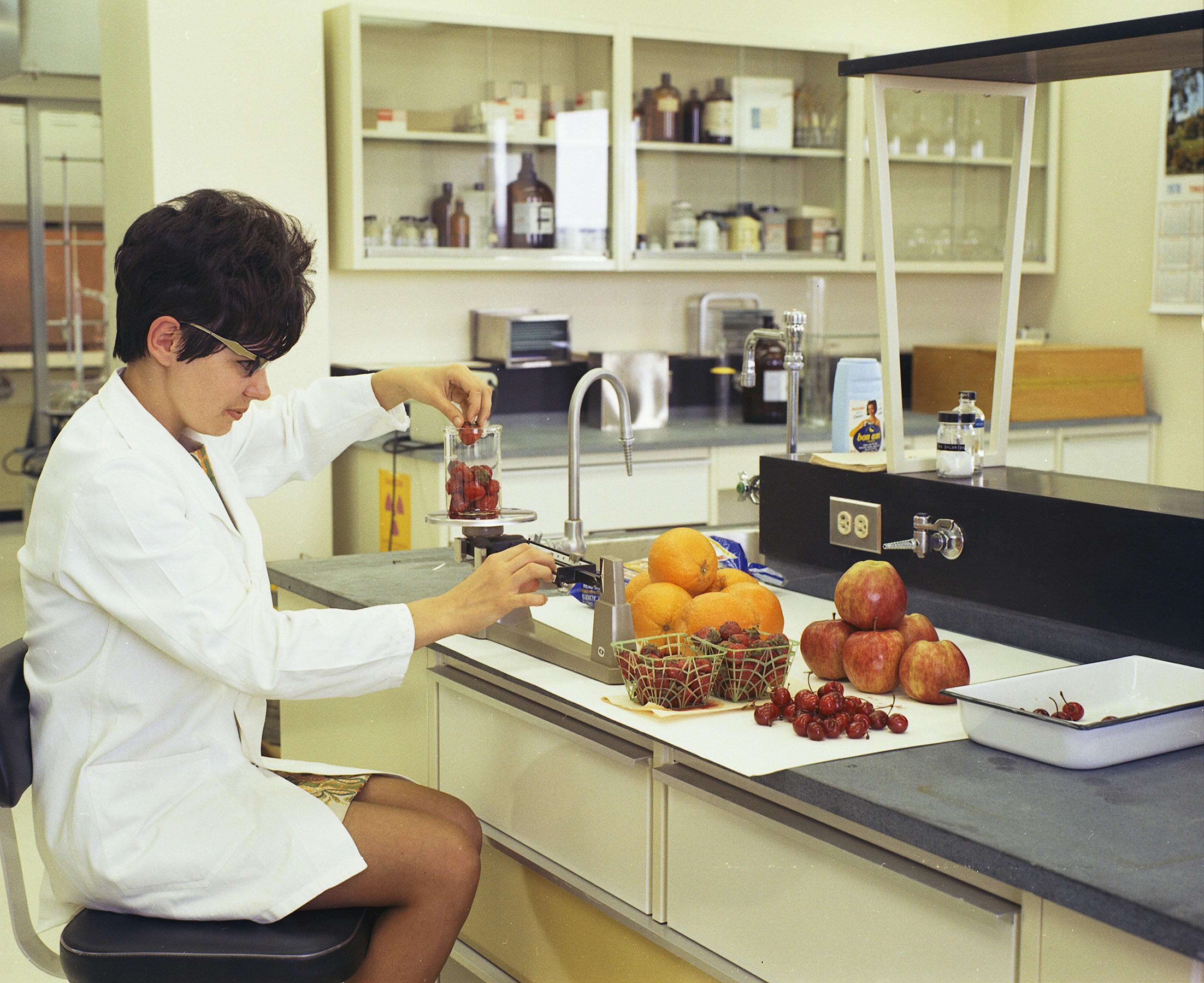 A technician tests a beverage sample in a food production lab.