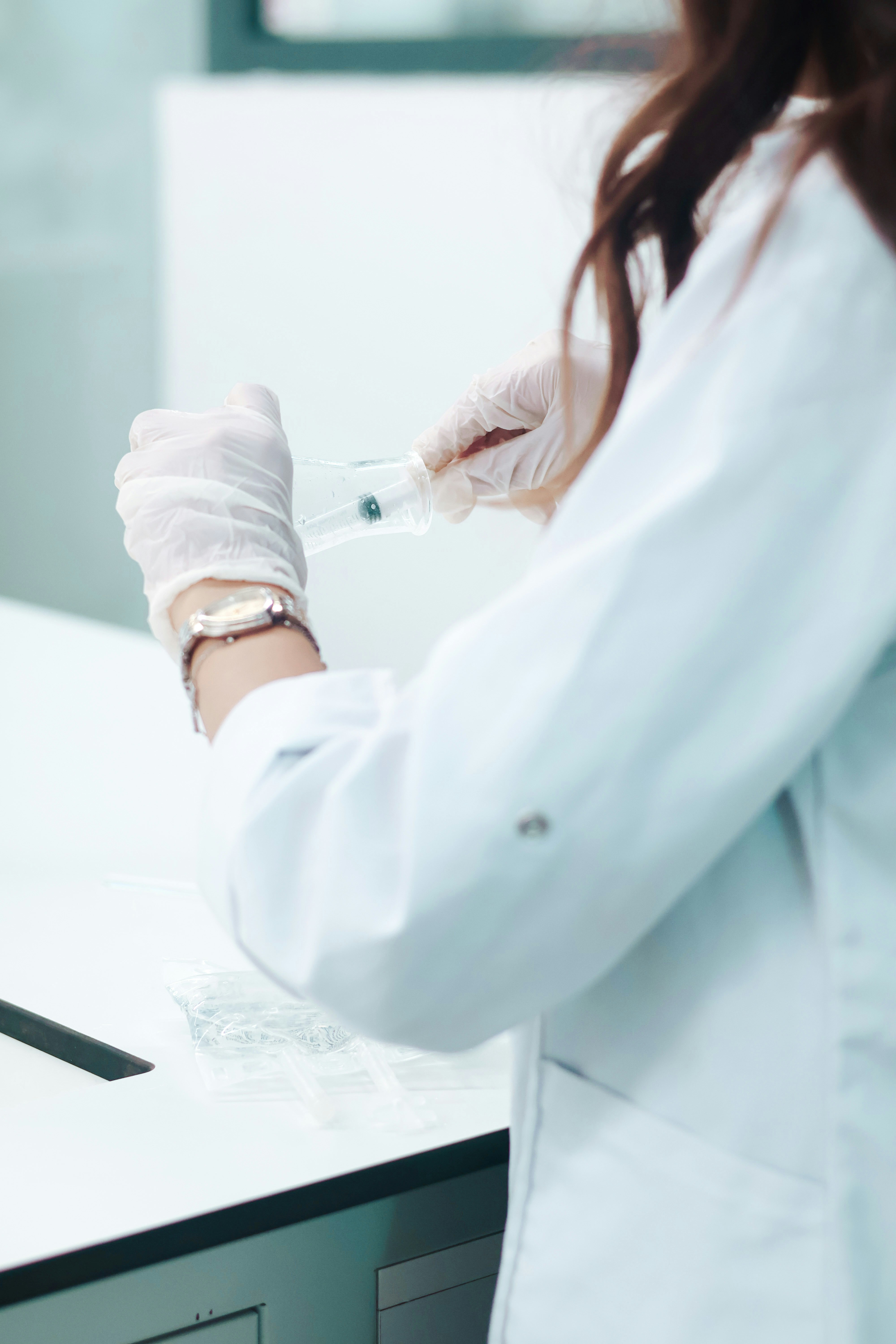 Quality-control scientist reviewing laboratory test records and specifications, representing traceability and compliance in lab data software.