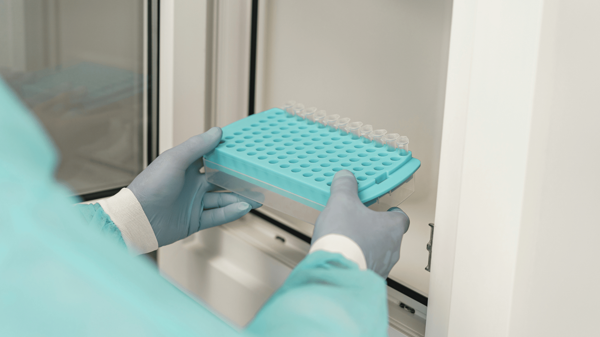 Scientist puts biobank samples in freezer.